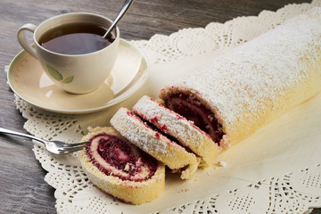 Homemade swiss roll cake with winter forest berries