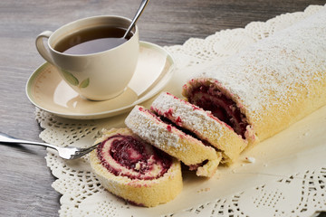 Delicious swiss roll cake with winter forest berries