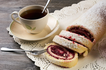 Homemade swiss roll cake with winter forest berries
