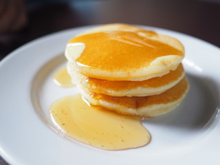 Stack of pancakes dessert with maple syrup.