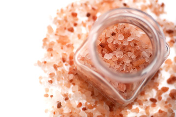 Fototapeta na wymiar Pink Himalayan salt in a jar on a white background. Big crystals in glass