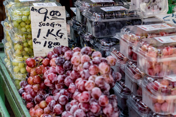 Purple grapes seller at the market