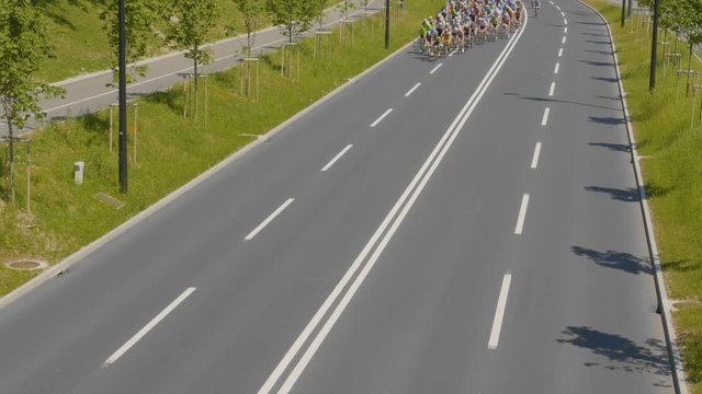 High POV of the amazing leading group of fast professional cyclists at a race on a sunny day.
