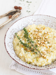 Risotto with green celery, turnip celery and taleggio cheese, decorated with thyme, roasted...