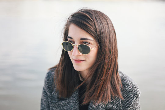 Portrait of a beautiful young woman with sunglasses outdoors