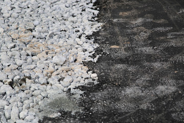 The end of the asphalt road End of the pavement. Asphalt road turns into a dirt road