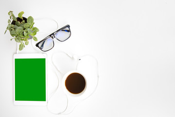 Work space office desk table top header layout side left relax break work in company drinking coffee cup play tablet listen music by earphone green screen