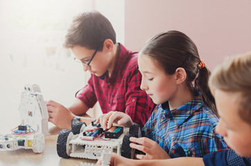 Stem education. Kids creating robots at school