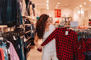 Picture showing beautiful woman shopping for clothes.