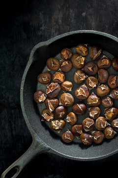 Roasted chestnuts in a cast iron pan