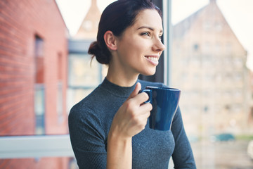 Positive woman with a cup of coffee