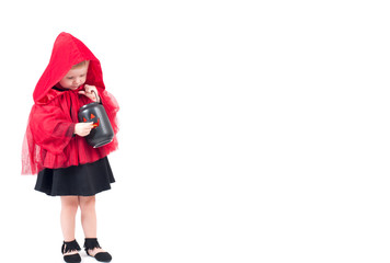 Halloween. Little Red Riding Hood. Beautiful little girl in a red raincoat.