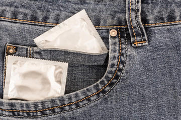 two condom in a pocket of worn jeans