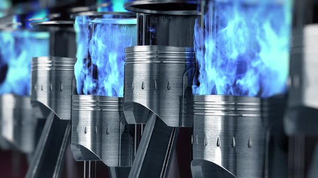 A close-up of engine in slow motion with a blue explosions of fuel. Loop