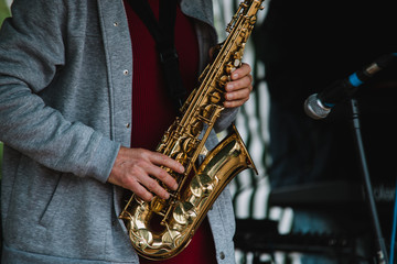 Fototapeta na wymiar Close up on saxofon player in the concert