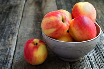 Apples in a bowl on a wooden  background