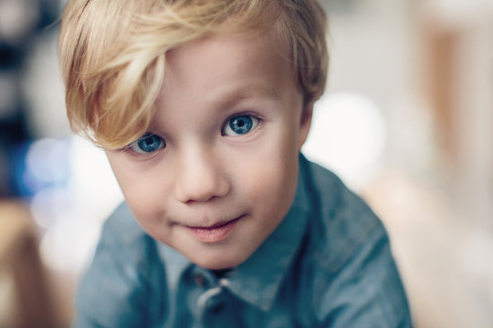 Curious young boy with big blue eyes