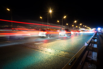 traffic light trails on a big road junction at night in a big city