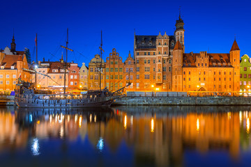 Old town of Gdansk at night reflected in Motlawa river, Poland