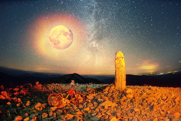 bike on a stone pillar tops at night