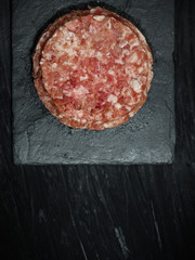 meat cutlet raw (minced) on a slate plate - tartar