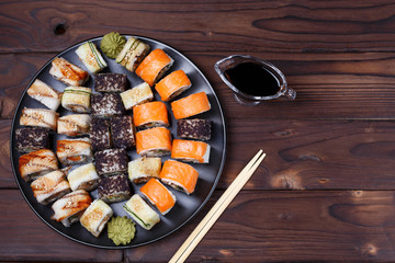 Colorful set of japanese sushi maki rolls with salmon, eel and caviar with chopsticks and say sauce,flat lay. Food art, traditional seafood, restaurant menu photo