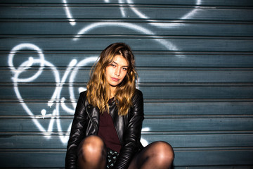 Young attractive woman sitting in the street
