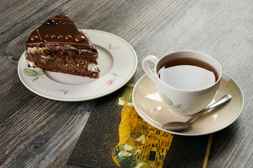 Slice of chocolate cake and cup of tea