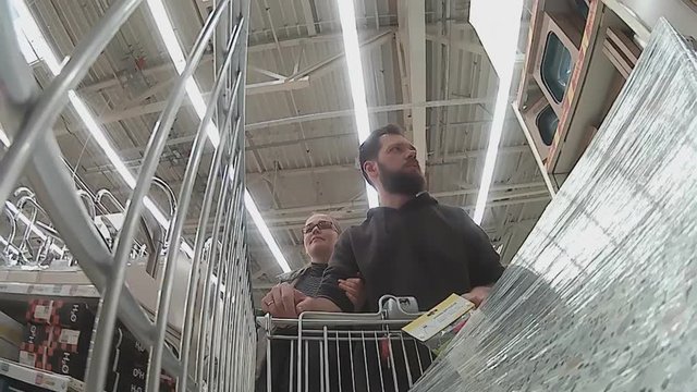 a young married couple shopping in a building materials supermarket