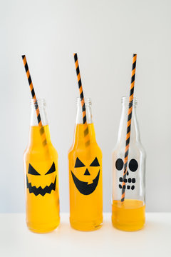 Jack-o'-lantern designs on orange beverages
