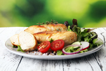 Grilled Chicken Breast with Salad and cherry tomatoes.