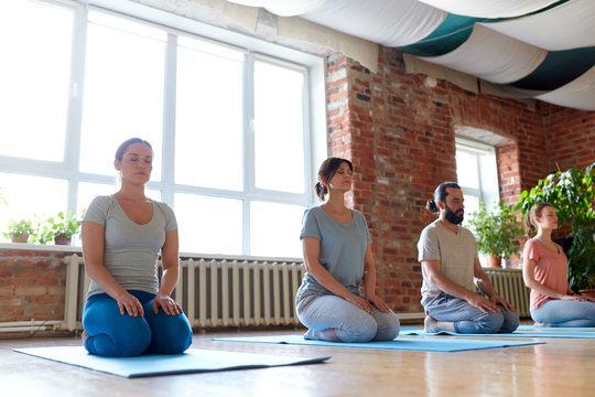 group of people meditating at yoga studio