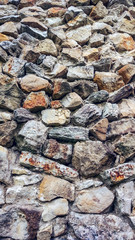 Stone old wall from huge blocks. Background of stones. The concept of reliability. Beautiful textured vintage antique background.