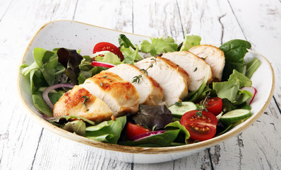 Chicken salad with leaf vegetables and cherry tomatoes.