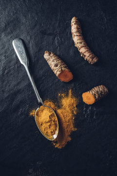 Food: Curcuma root and powder on spoon