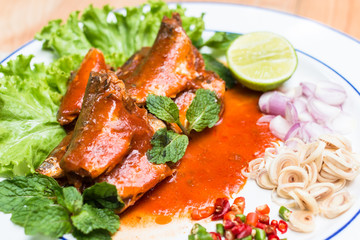 Mackerel fish in tomato sauce and cook in Thai spicy salad.