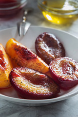 Baked plums and peaches with honey and cinnamon