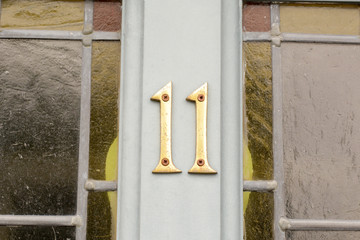 House number 11 sign on door