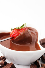 Fondue with Melting chocolate or melted chocolate and strawberry.