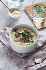 Mushroom cream soup with in a white bowl