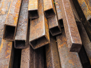 Background of rusty construction rebar, pipe and channel.
