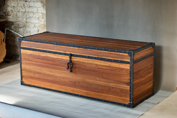 Solid teak chest. Wooden storage chest with metal frames on the corners
