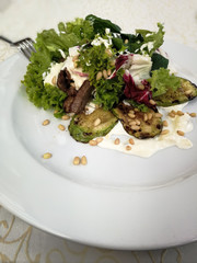 salad with meat. On a white plate.