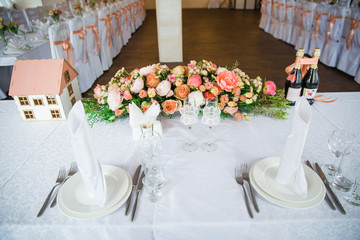 table serving with dishes and flowers in hall