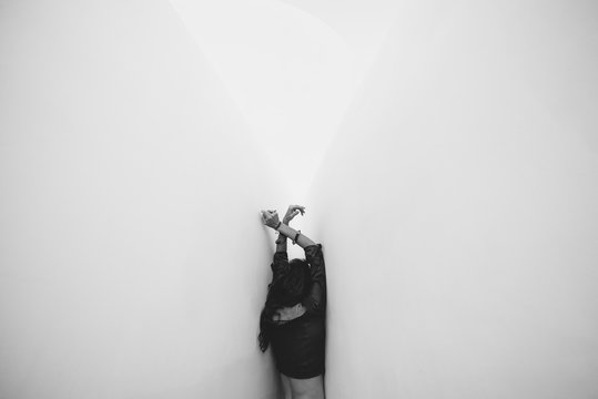 Woman By White Wall