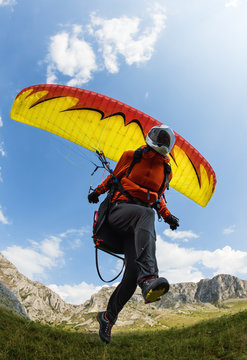 Paraglider taking off from the ground