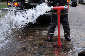 The fireman opens a fire hydrant to extinguish a fire