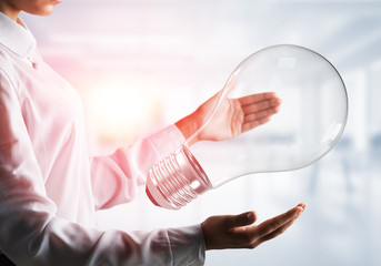 Good idea concept by means of lightbulb in hands.