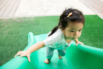 A little girl is playing in playground
