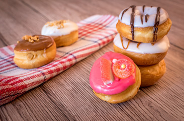 Naklejka na ściany i meble Multi colored donuts on the table